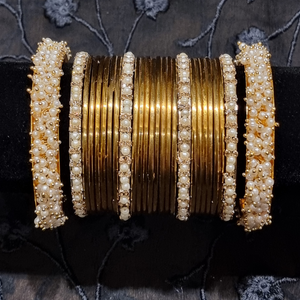 Gold metal bangles set with ivory and golden kangan bangles with pearls
