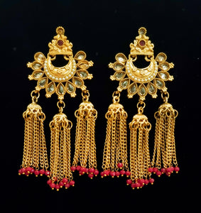 Gold plated kundan earrings with tassel jhumkis.