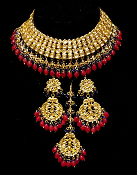 Bridal kundan piece is four layered set with dangling emeralds to match your festive.