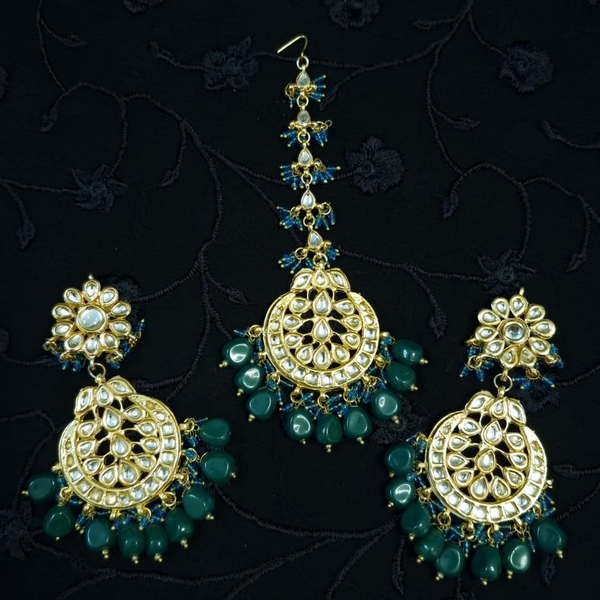Bridal kundan piece is four layered set with dangling emeralds to match your festive.