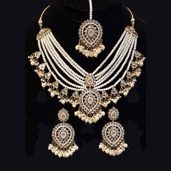 Designer kundan and pearl layered rani haar with earrings and tikka.